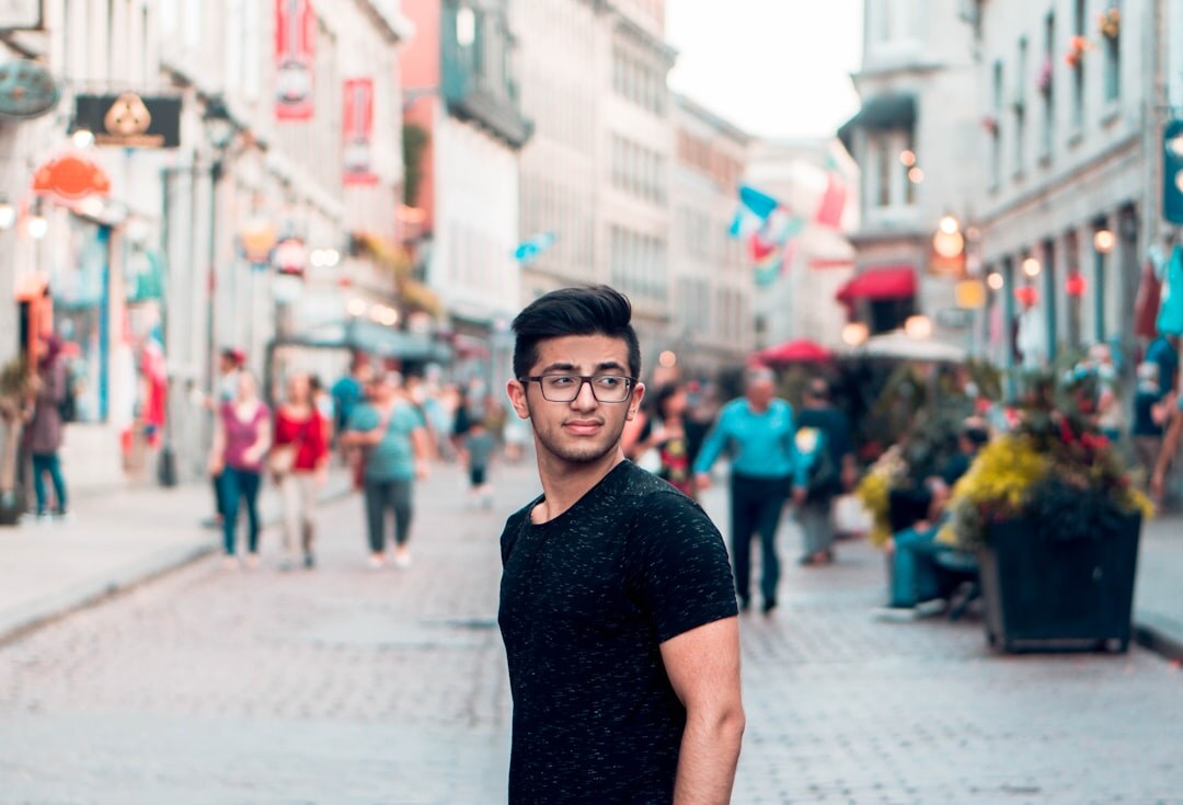 man standing heroically in city